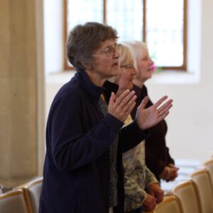 A woman worshipping in a service